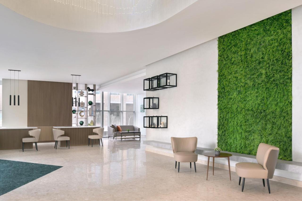 Element By Westin West Bay Doha Hotell Exteriör bild A green wall in a hotel lobby